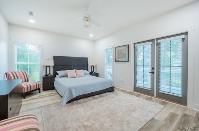 bedroom with french doors, access to outside, light hardwood / wood-style floors, and ceiling fan