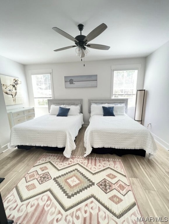 bedroom featuring ceiling fan and light hardwood / wood-style flooring