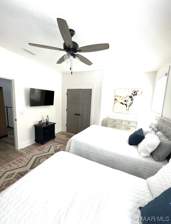 bedroom featuring ceiling fan and dark hardwood / wood-style floors