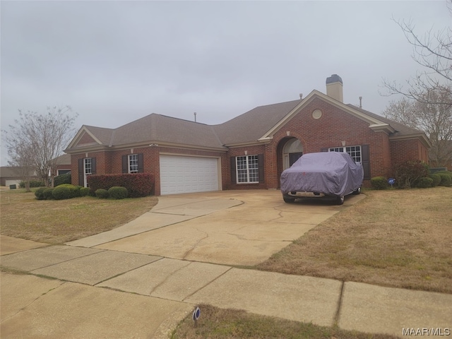 single story home with a front yard and a garage