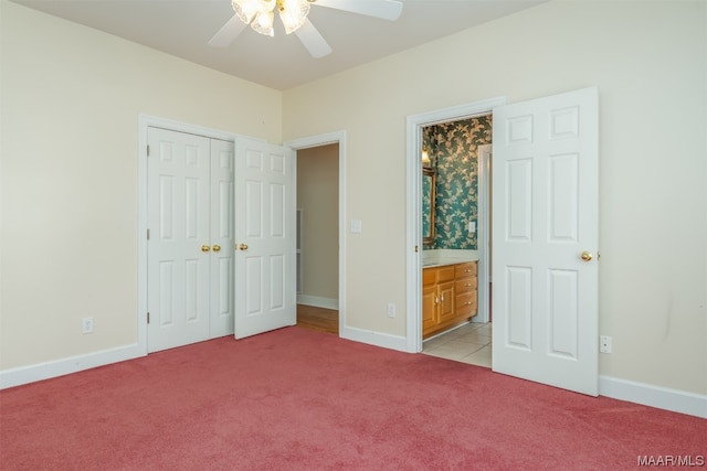 unfurnished bedroom featuring light colored carpet, a closet, and ceiling fan