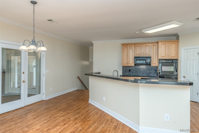 kitchen featuring light wood-type flooring, black appliances, decorative light fixtures, tasteful backsplash, and light brown cabinets