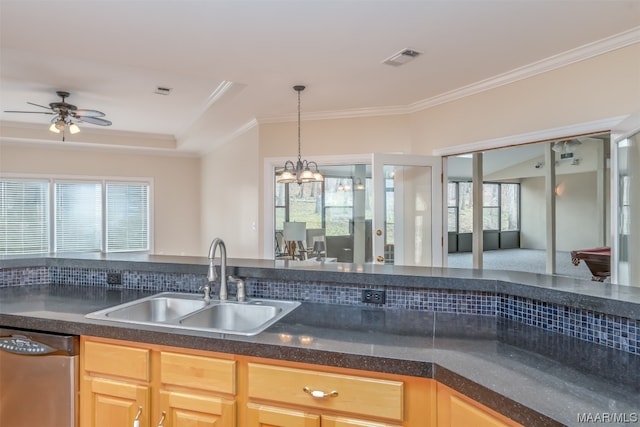 kitchen featuring a wealth of natural light, sink, stainless steel dishwasher, and ceiling fan with notable chandelier