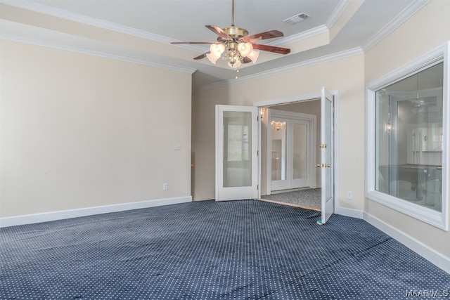 carpeted empty room with french doors, ornamental molding, ceiling fan, and a tray ceiling