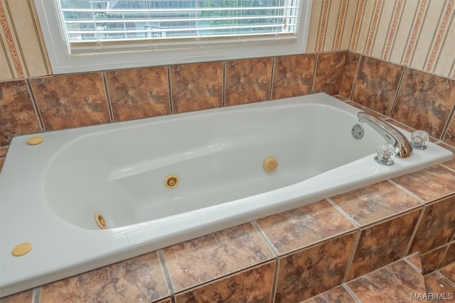 bathroom with tiled tub and tile floors