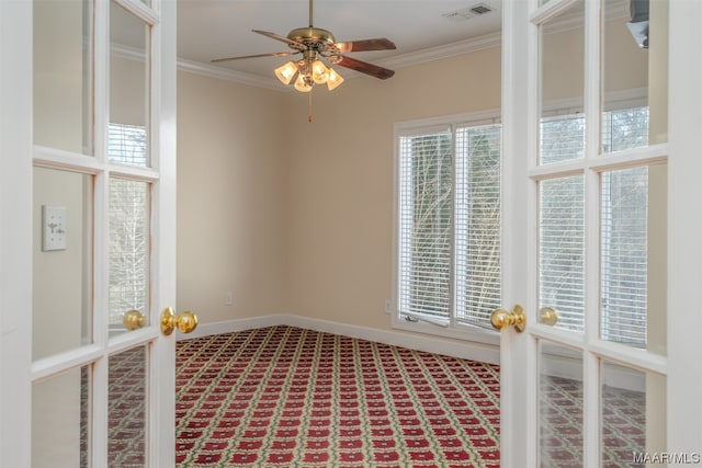 unfurnished room featuring a healthy amount of sunlight, ornamental molding, and ceiling fan