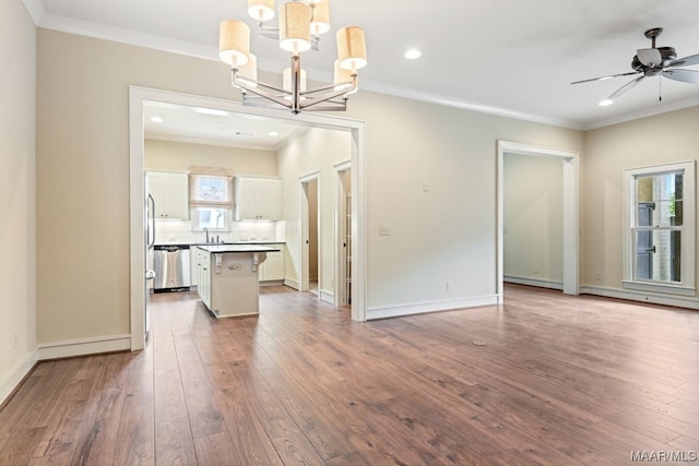 interior space featuring ornamental molding, light hardwood / wood-style flooring, ceiling fan with notable chandelier, and sink