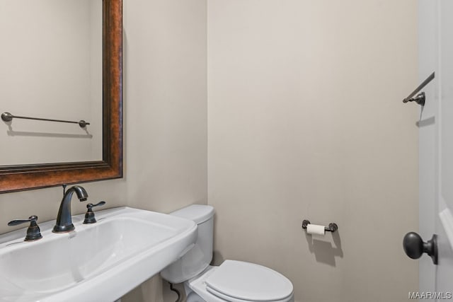 bathroom with toilet and sink