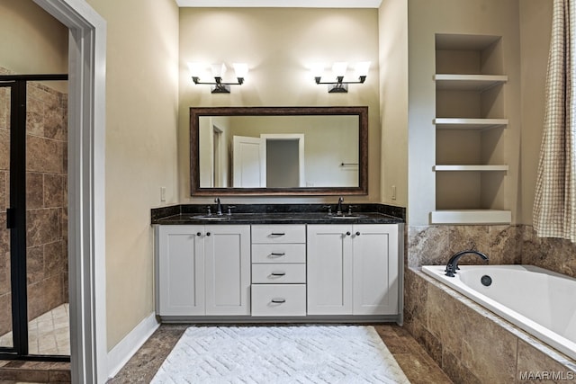 bathroom featuring dual sinks, built in shelves, tile floors, and tiled tub