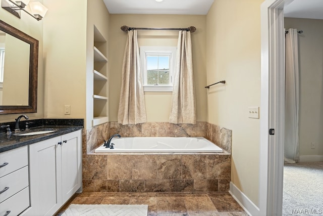 bathroom with a relaxing tiled bath and vanity