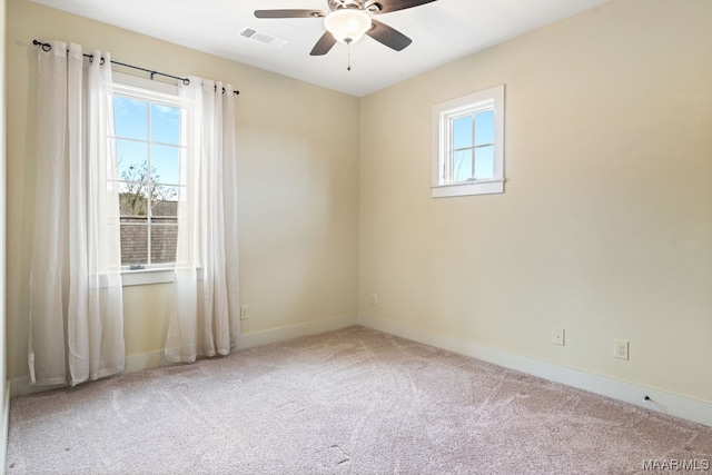 unfurnished room with ceiling fan and light carpet