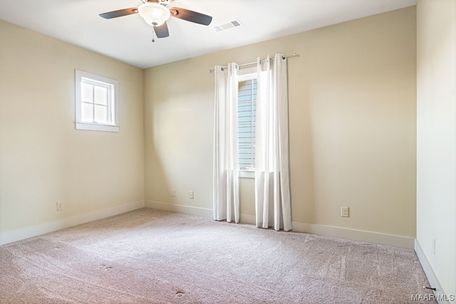 spare room with light colored carpet and ceiling fan