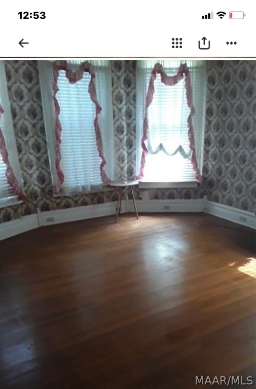 empty room featuring dark hardwood / wood-style flooring