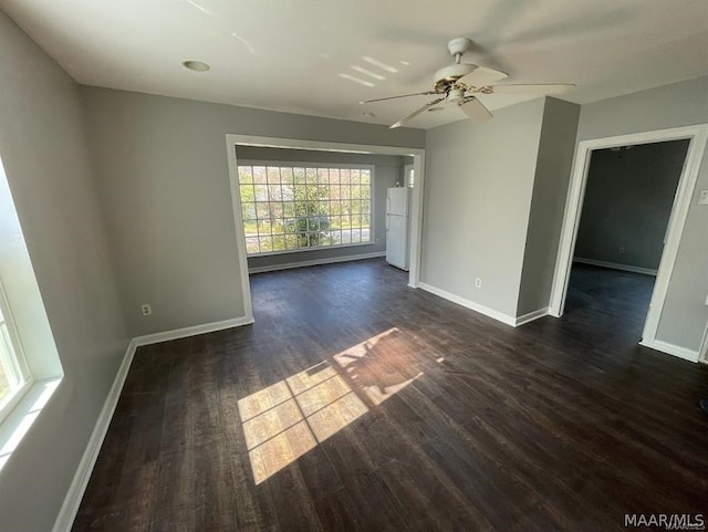 unfurnished room with ceiling fan and dark hardwood / wood-style floors