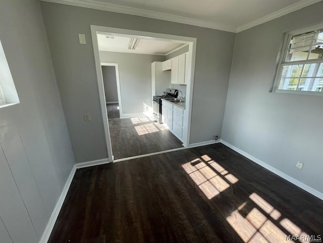 spare room with crown molding and dark hardwood / wood-style flooring