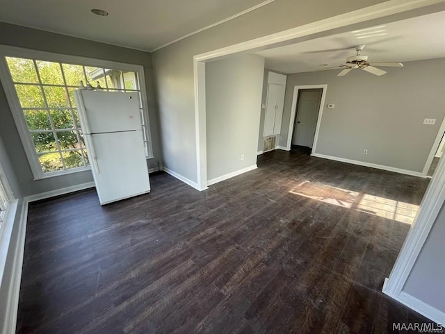 unfurnished room with ceiling fan and dark wood-type flooring