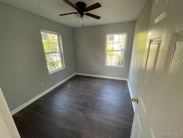 unfurnished room with dark hardwood / wood-style flooring, ceiling fan, and plenty of natural light