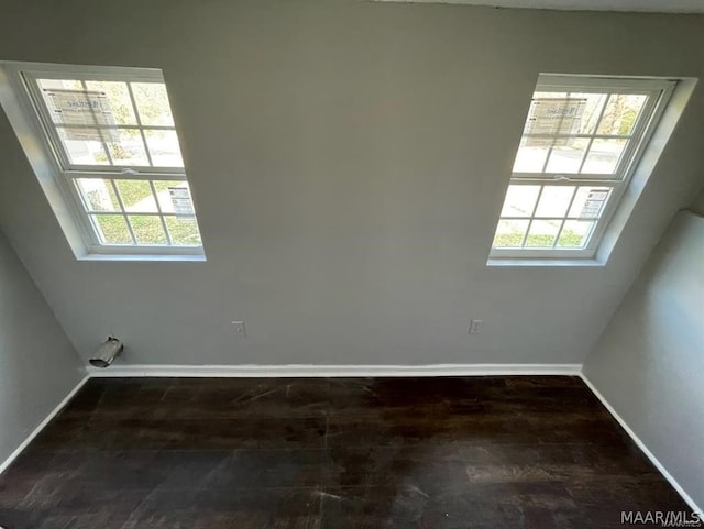 spare room with dark wood-type flooring