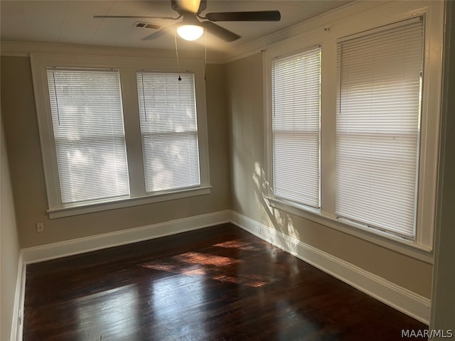 unfurnished room featuring ceiling fan, dark wood-type flooring, and ornamental molding