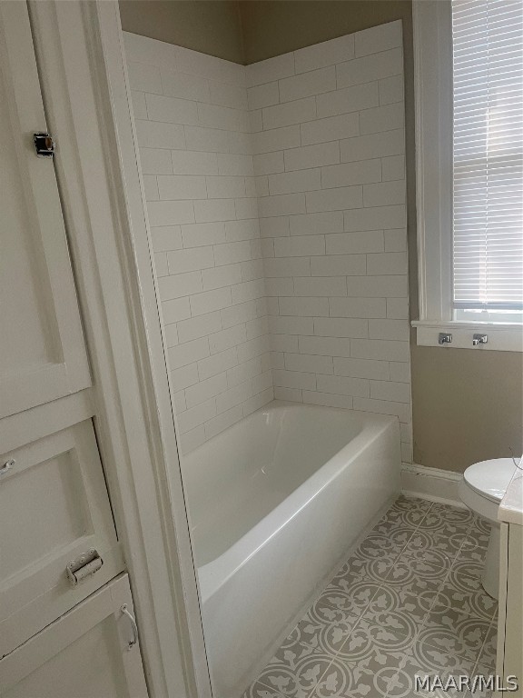 full bathroom with tile flooring, toilet, vanity, and bathtub / shower combination