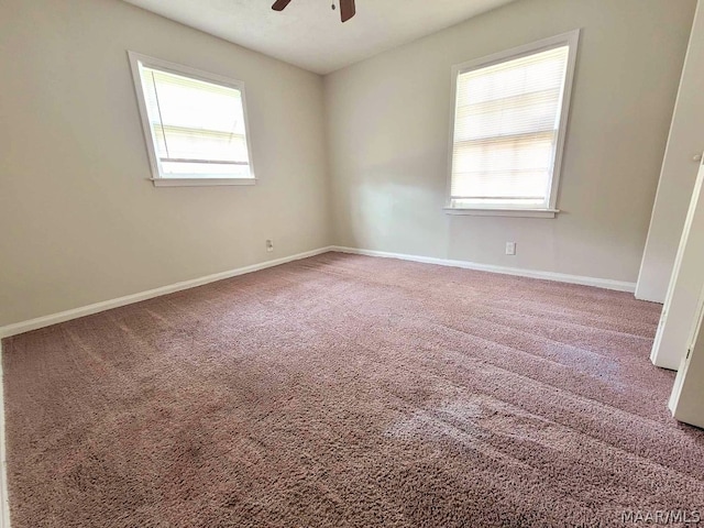 carpeted empty room featuring ceiling fan