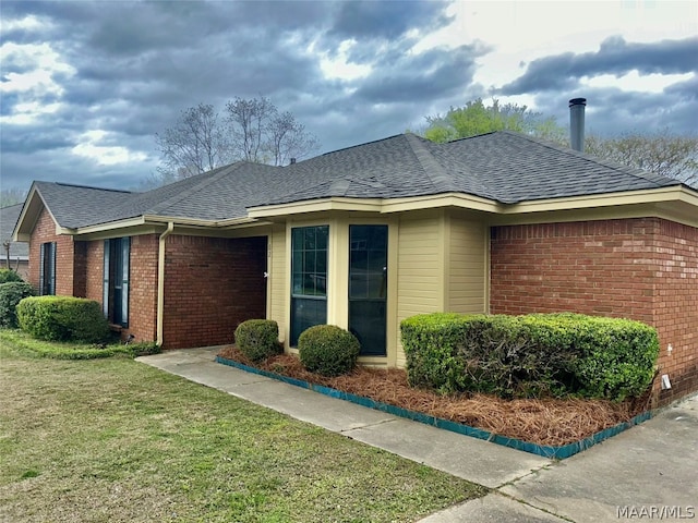 ranch-style home with a front lawn