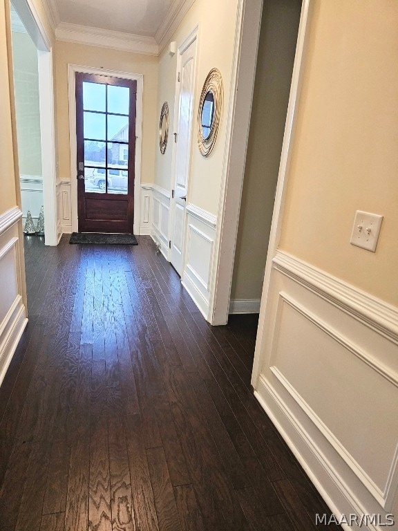 entryway with dark hardwood / wood-style floors and ornamental molding