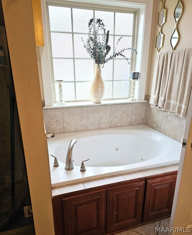 bathroom with plenty of natural light and a bathtub