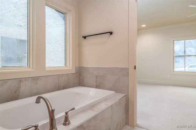 bathroom featuring tiled tub