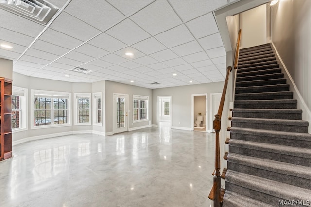 interior space with a paneled ceiling