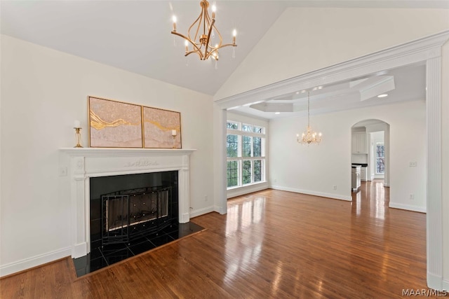 unfurnished living room featuring high vaulted ceiling and hardwood / wood-style floors