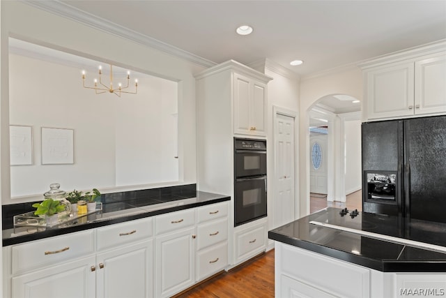 kitchen featuring crown molding, white cabinets, black appliances, and light wood-type flooring