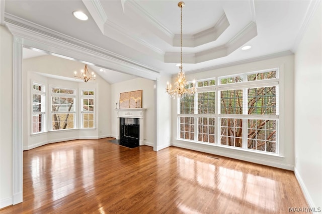 unfurnished living room featuring crown molding, hardwood / wood-style floors, and plenty of natural light