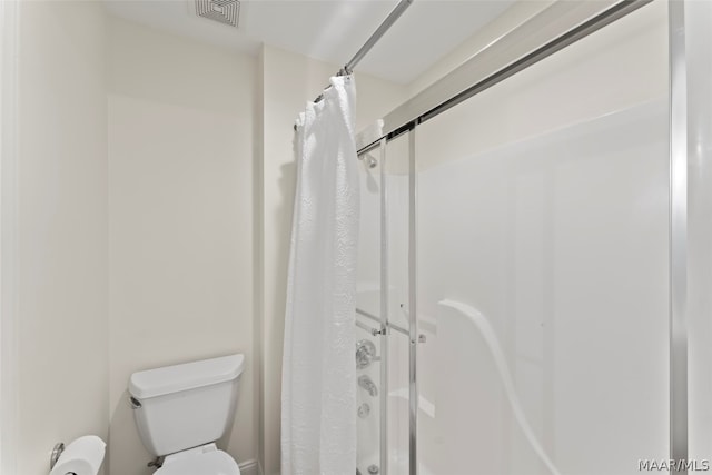 bathroom with toilet and walk in shower