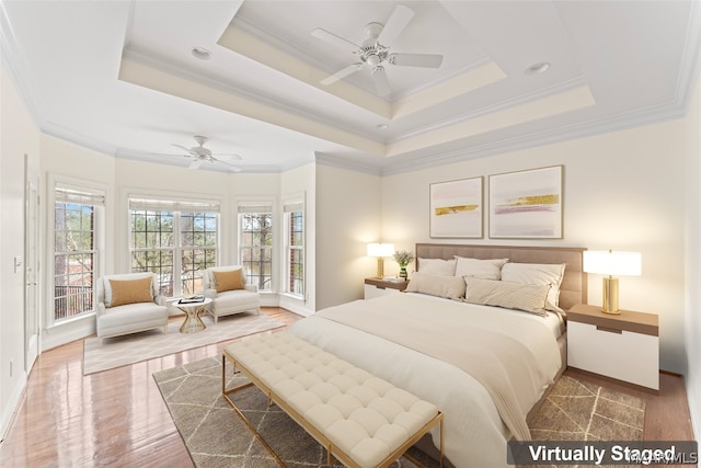 bedroom with crown molding, hardwood / wood-style flooring, and ceiling fan