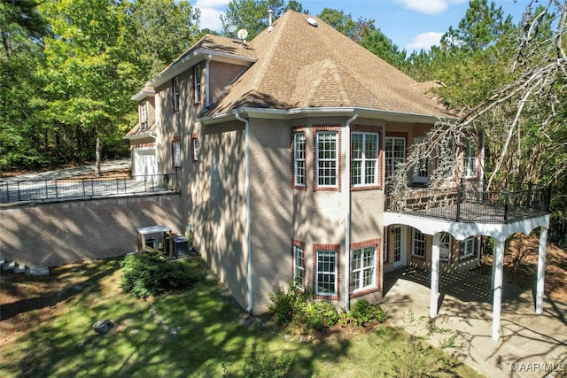 rear view of property featuring a patio and cooling unit