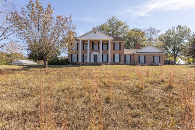 back of property with a lawn