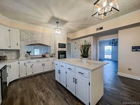 kitchen with decorative light fixtures, dark hardwood / wood-style floors, a kitchen island, and white cabinets