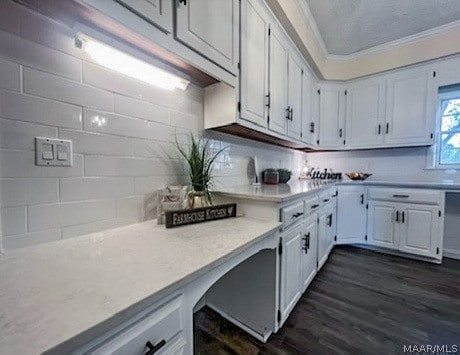 kitchen featuring white cabinets, backsplash, ornamental molding, and dark wood-type flooring