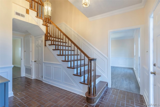 staircase featuring crown molding