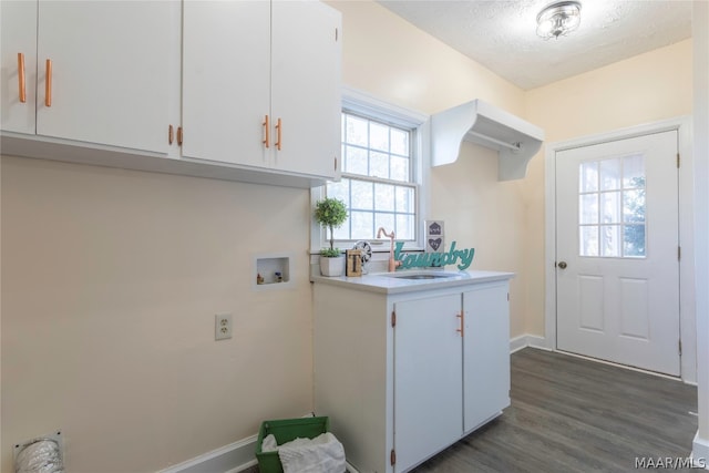 kitchen featuring plenty of natural light, white cabinetry, dark wood-type flooring, and sink