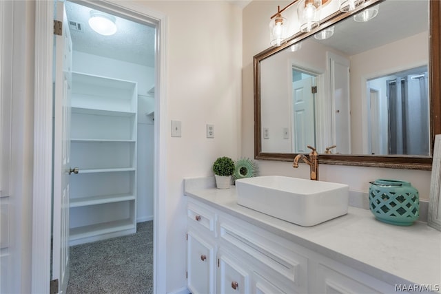 bathroom with a textured ceiling and oversized vanity