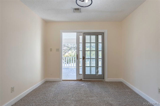 entryway with carpet flooring, a textured ceiling, and french doors