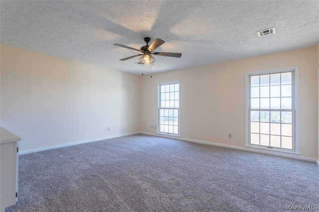 unfurnished room with carpet flooring, a textured ceiling, and ceiling fan