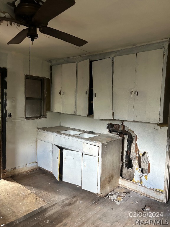 kitchen with ceiling fan and dark hardwood / wood-style flooring