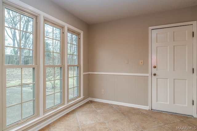 tiled spare room with plenty of natural light