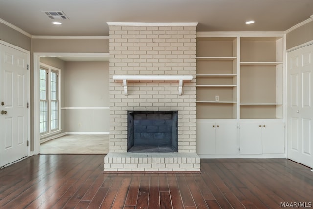 unfurnished living room with dark hardwood / wood-style floors, brick wall, and a brick fireplace