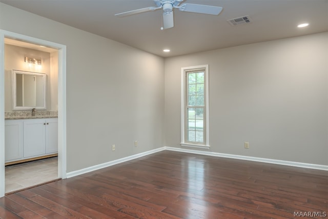 unfurnished room with ceiling fan and dark wood-type flooring