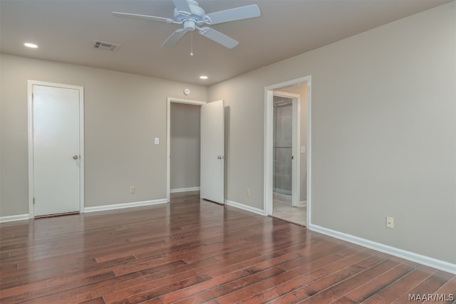 spare room with ceiling fan and dark wood-type flooring