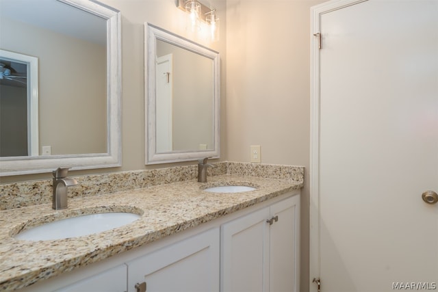 bathroom with dual bowl vanity and ceiling fan